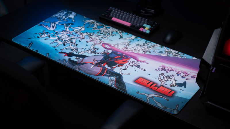 Premium gaming setup featuring the Kill la Kill “Ryuko’s Rampage” anime deskmat with intense battle artwork, colorful keyboard, and gaming mouse.