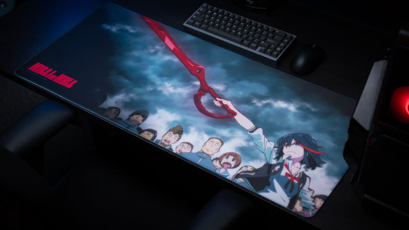 Gaming desk setup featuring the Kill la Kill “Scissorblade” anime deskmat with Ryuko wielding the Scissor Blade beneath stormy skies.