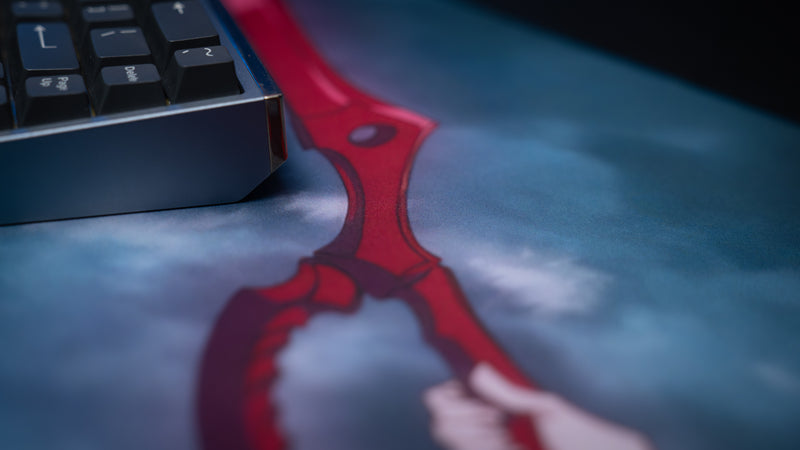 Close-up of the Kill la Kill “Scissorblade” anime deskmat featuring detailed red Scissor Blade artwork beside a mechanical keyboard.