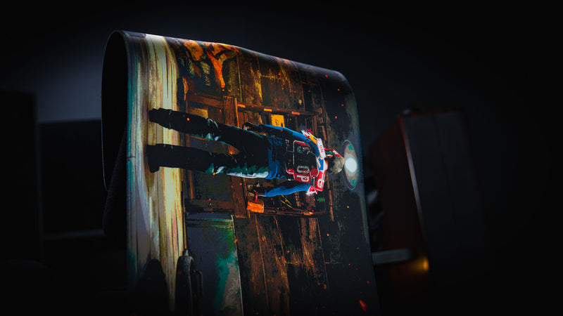 Last Man Standing official Rust gaming deskmat draped over a chair to showcase its flexible premium cloth surface, stitched edges, and cinematic survivor artwork.