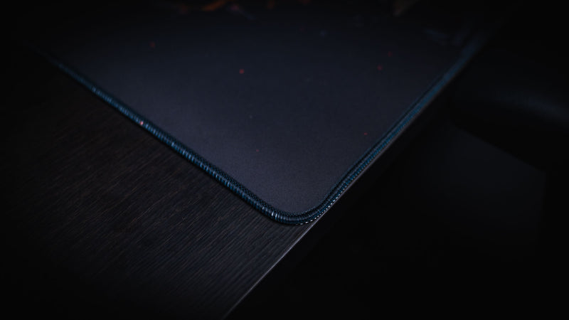 Close-up of the Last Man Standing official Rust gaming deskmat highlighting the premium stitched corner, smooth cloth surface, and high-definition print quality.