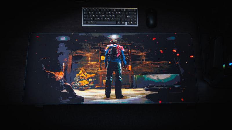 Top-down view of the Last Man Standing official Rust gaming deskmat featuring a lone survivor standing inside a dimly lit base preparing for the fight ahead.