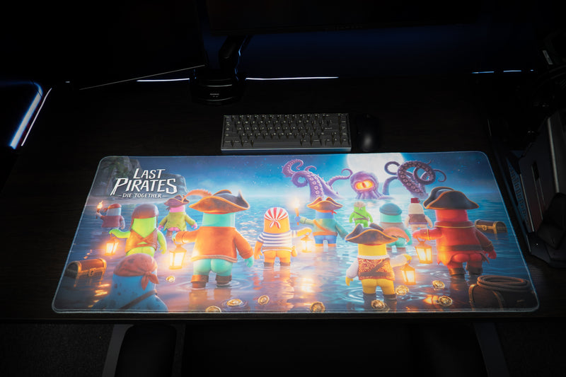 Kraken Tide desk mat laid flat on a dark gaming desk beneath a keyboard