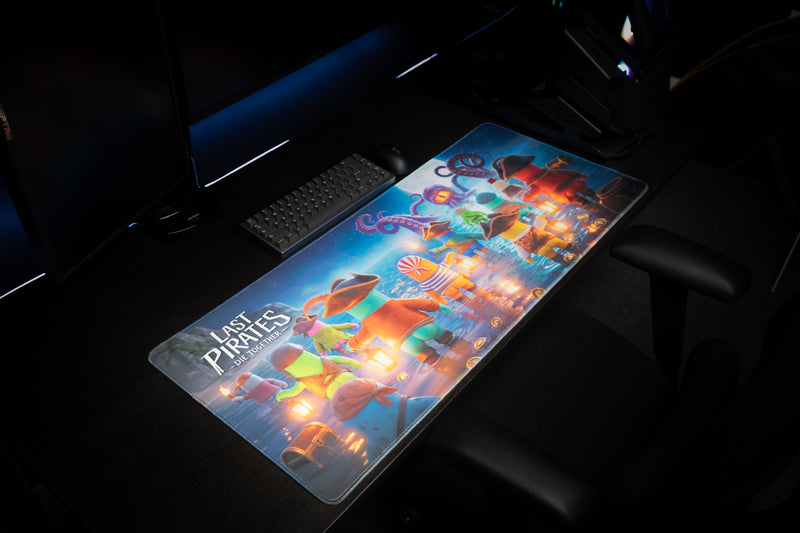 Angled view of the Kraken Tide desk mat with pirate crew artwork on a gaming setup