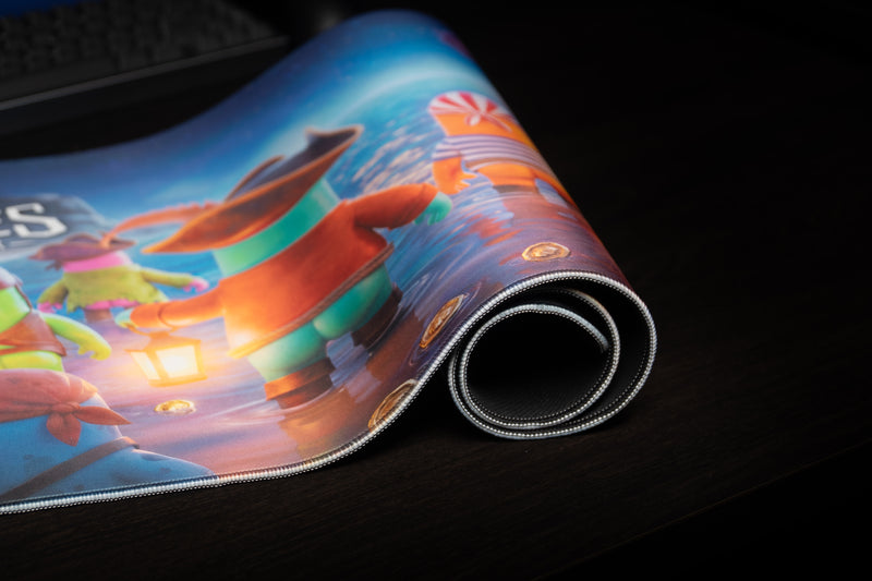 Rolled Kraken Tide desk mat showing stitched edges, rubber underside, and colorful pirate artwork