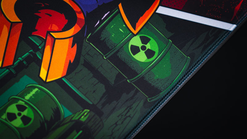 Close-up of the Lure of the Night gaming deskmat showcasing premium stitched edges, vibrant comic-style artwork, and Rust-inspired industrial details.