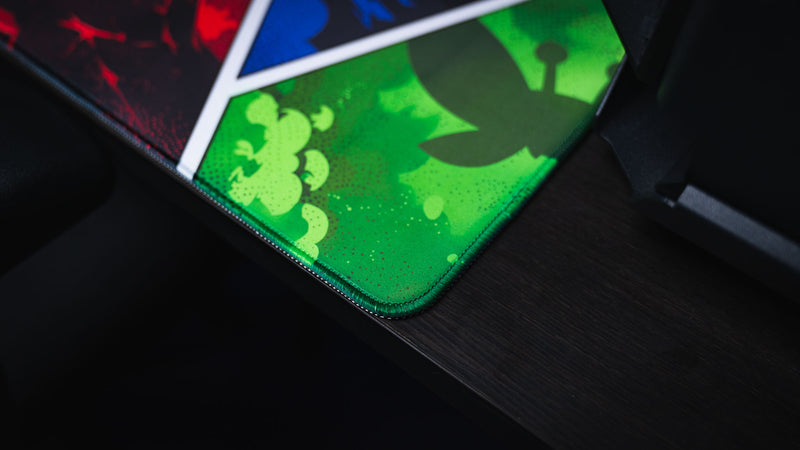 Close-up of the Lure of the Night gaming deskmat highlighting the premium stitched edge and vibrant green comic-style panel with Rust-inspired artwork.