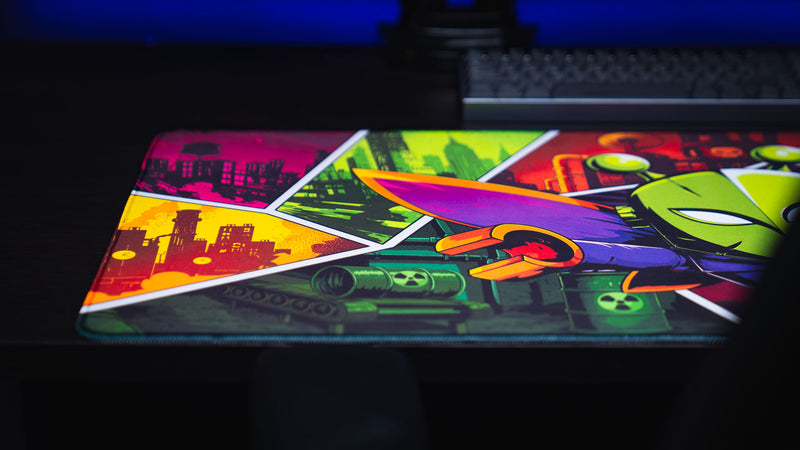Close-up of the Lure of the Night gaming deskmat showcasing vibrant comic-inspired artwork with a colorful moth character and post-apocalyptic Rust-themed panels.