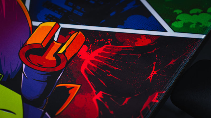Close-up of the Lure of the Night gaming deskmat highlighting the volcanic comic-style panel, vibrant colors, and premium stitched edge.
