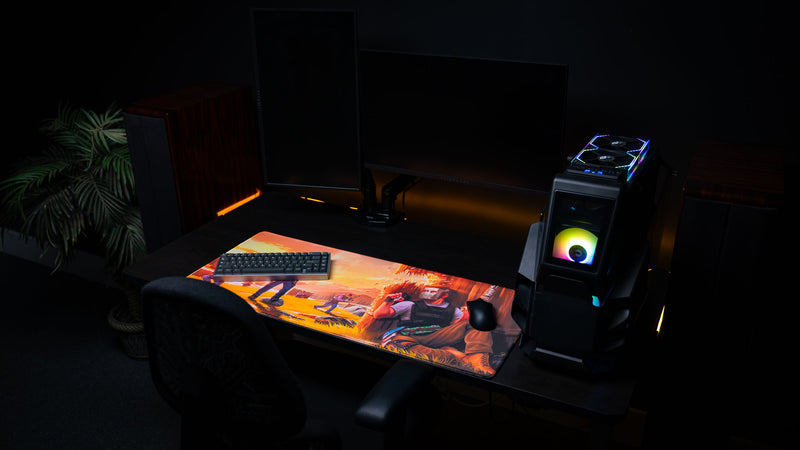 Wide gaming desk setup featuring the main scene Rust deskmat with a mechanical keyboard, gaming mouse, RGB gaming PC, and dual monitors, showcasing the full artwork, vibrant colors, premium stitched edges, and oversized gaming mouse pad.