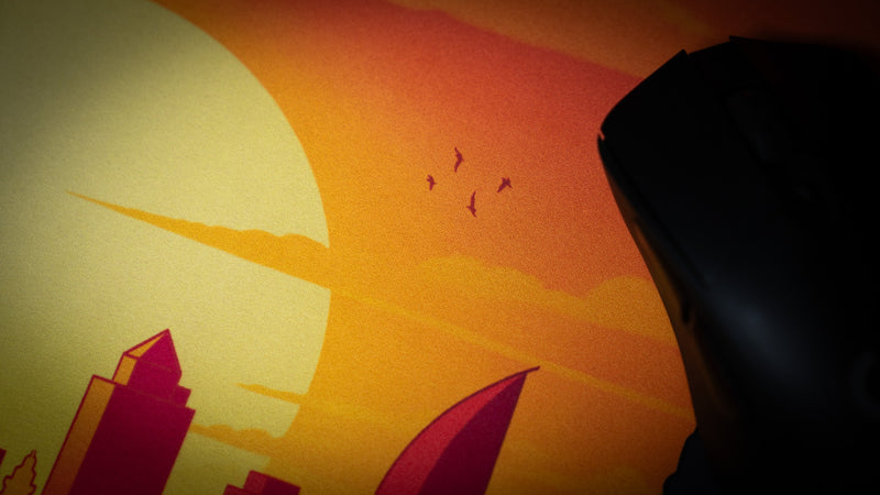 Macro view of the golden sunset print and LuxeWeave Precision surface on the MapleTakes Golden Hour Defiance deskmat