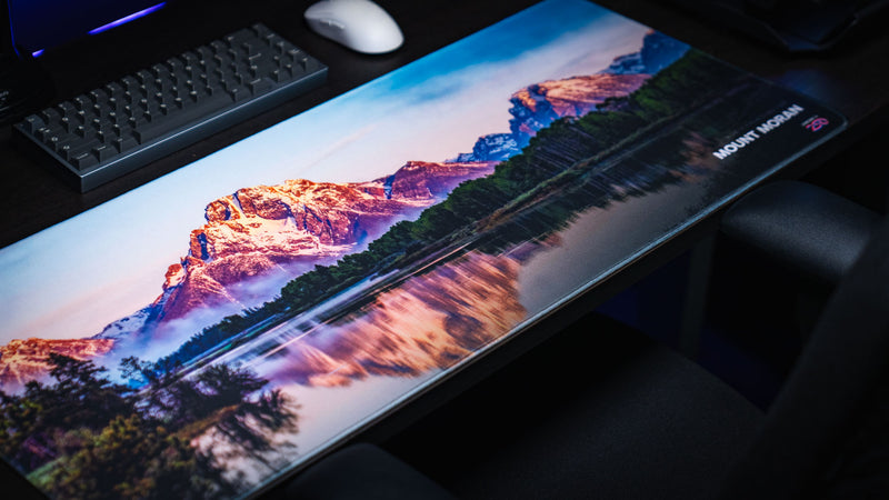 Mount Moran deskmat showcasing a panoramic Grand Teton National Park landscape with snow-capped peaks, lake reflections, premium stitched edges, and vibrant HD photography.