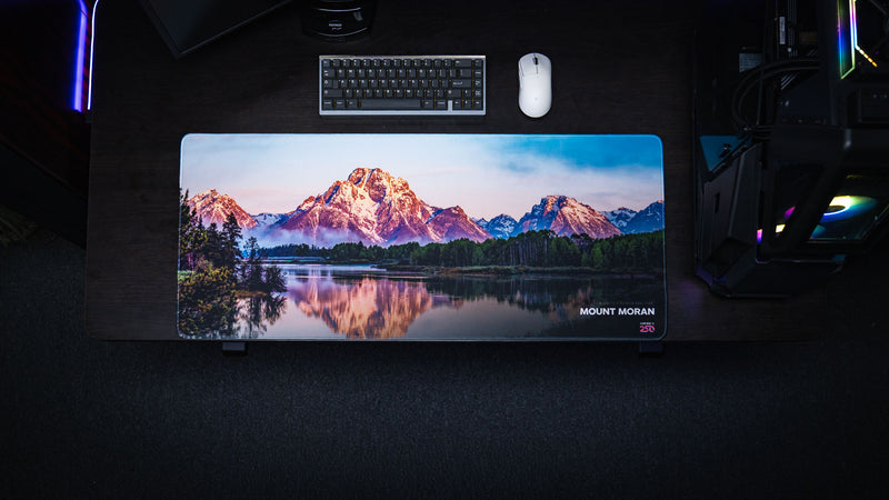 op-down view of the Mount Moran deskmat featuring Grand Teton National Park with mountain reflections, premium stitched edges, and vibrant HD landscape photography.