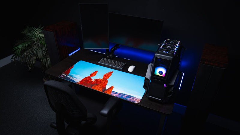 Navajo Loop Trail deskmat displayed in a modern gaming workstation, showcasing Bryce Canyon's iconic Thor's Hammer hoodoo with premium stitched edges and vibrant HD photography.