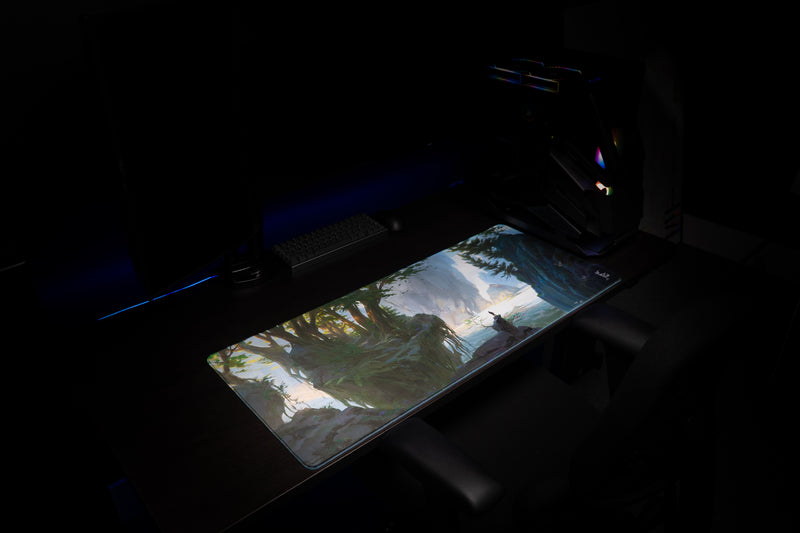 Angled view of the Lake of Laugg deskmat on a dark gaming setup with keyboard and PC tower