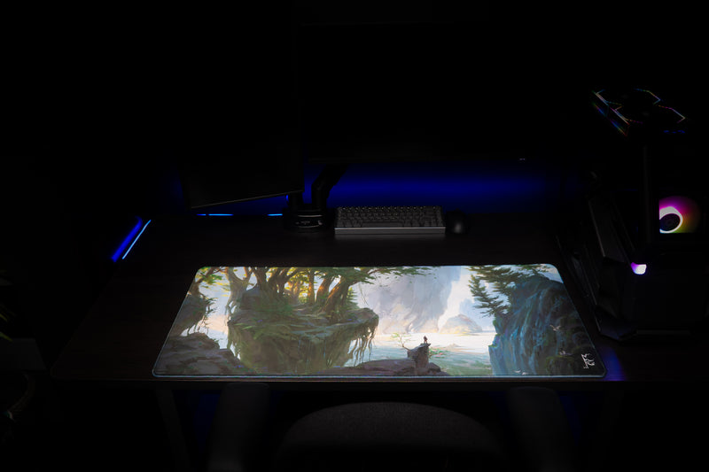 Lake of Laugg deskmat laid flat on a dark gaming desk beneath a keyboard and mouse