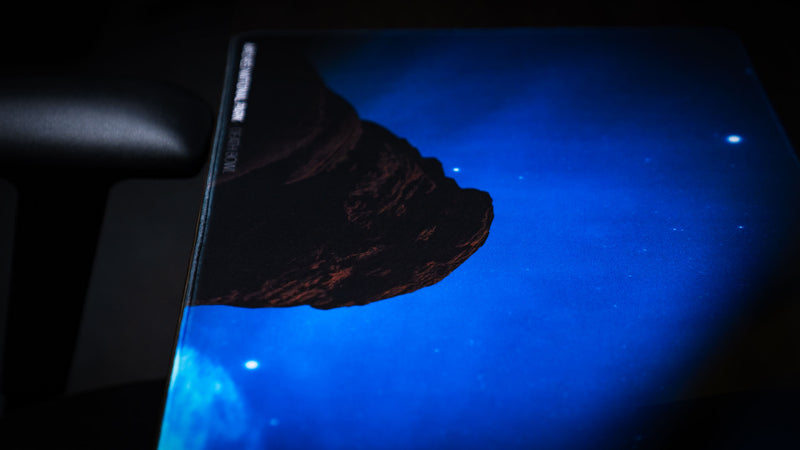 Close-up detail of the Nightsky Death Bowl deskmat highlighting the illuminated night sky, stars, and iconic rock formation from Arches National Park with premium print quality.