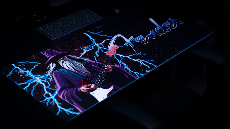 Close view highlighting the wizard guitarist and glowing blue energy on the Fender desk mat