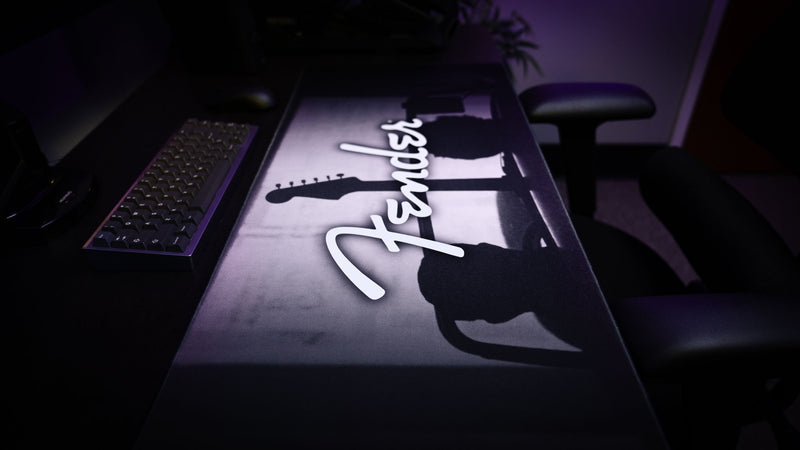 Fender Family Night Out 1954 XXL desk mat shown beneath a keyboard and mouse in a desktop setup