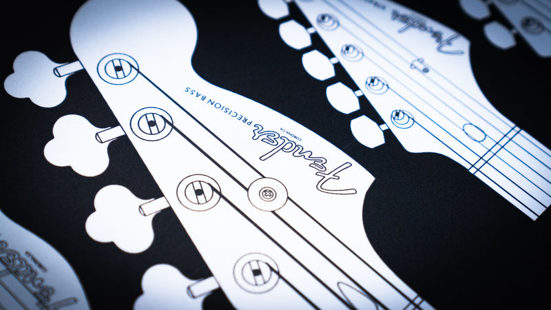 Fender Headstocks desk mat featuring classic guitar and bass silhouettes across a deep black surface