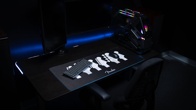 Fender Headstocks XXL desk mat shown beneath a keyboard and mouse in a desktop setup