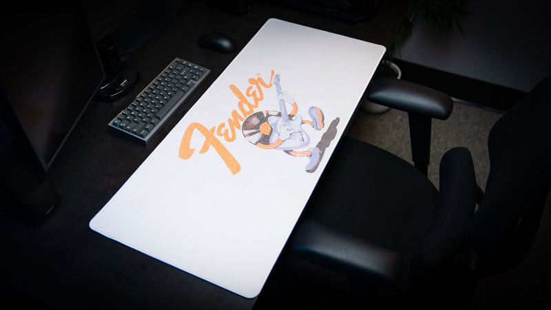 Close view highlighting the vintage Fender logo and guitar character printed on the desk mat