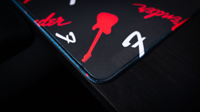 Fender Repeat desk mat with bold branded artwork beneath a keyboard and mouse area