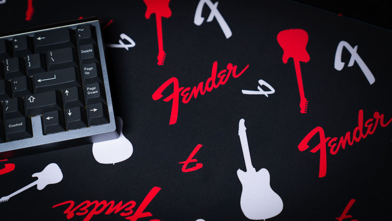 Close view showing the crisp repeating Fender print on the black desk mat