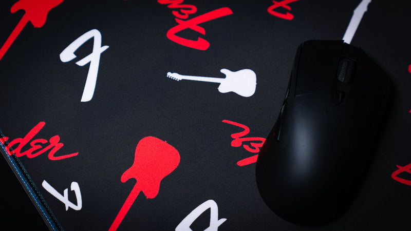 Fender Repeat desk mat with a modern red-and-black pattern of logos and guitar silhouettes