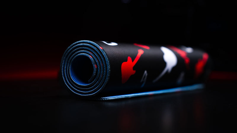 Close detail of the red Fender pattern printed across the smooth black mouse surface