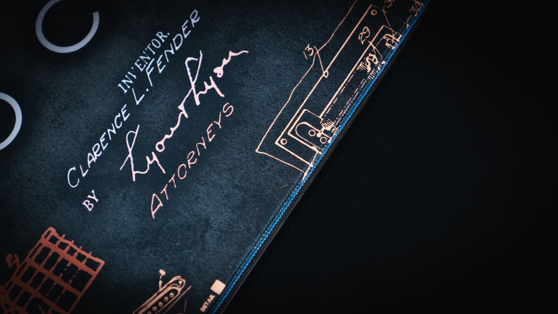 Full-width gold Stratocaster Blueprint desk mat showing technical guitar construction drawings
