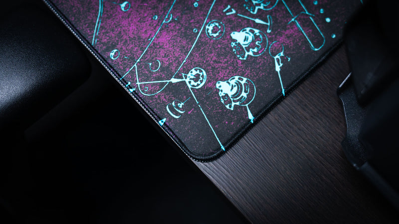 Full-desk view of the purple Fender Stratocaster Blueprint XXL mat beneath a keyboard and mouse