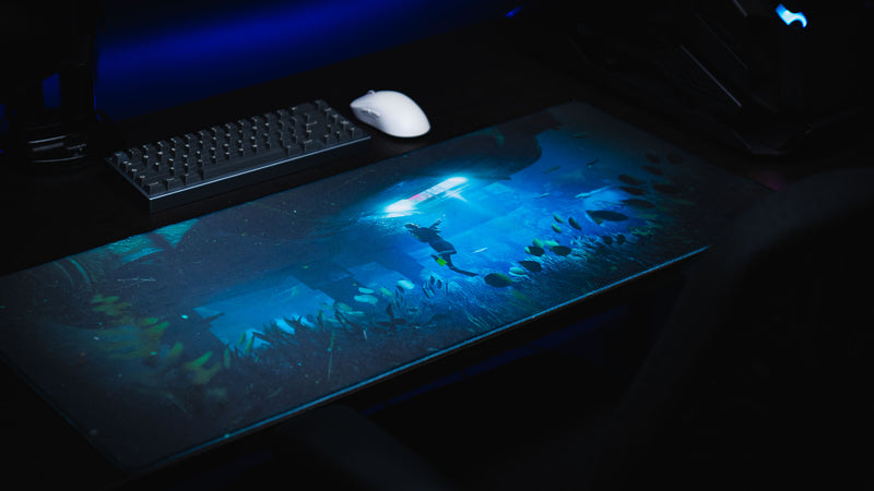 Official Rust Labs Breach deskmat displayed on a gaming desk, featuring an underwater monument raid scene with premium stitched edges and vibrant HD artwork.