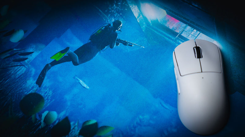 Close-up of the Official Rust Labs Breach deskmat featuring a scuba diver approaching the underwater Labs monument, showcasing vibrant blue ocean lighting, marine life, and a smooth precision surface.