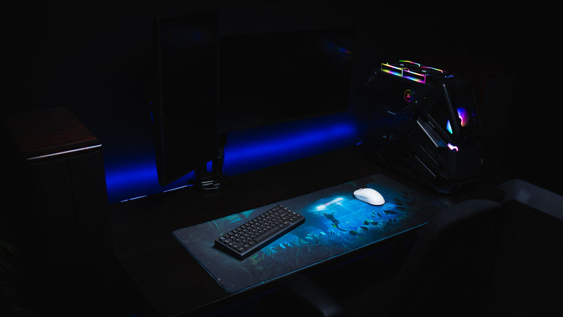 Gaming desk setup featuring the Official Rust Labs Breach deskmat with immersive underwater artwork, mechanical keyboard, gaming mouse, and RGB PC build.