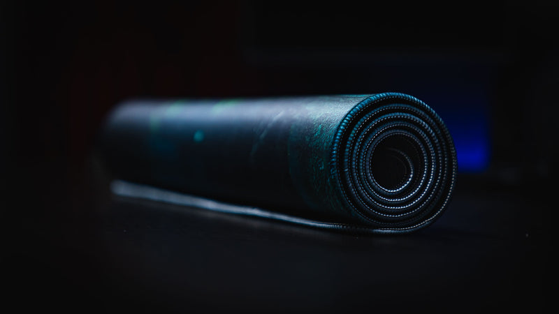 Rolled Official Rust Labs Breach deskmat showcasing its flexible premium cloth surface, stitched edges, and durable construction for easy storage and travel.