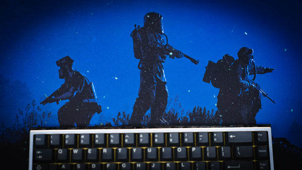 Close-up of the Official Rust Twilight Roam deskmat featuring three hazmat survivors silhouetted beneath a moonlit night sky with a mechanical keyboard in the foreground.