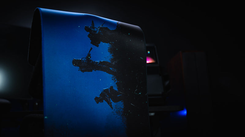 Official Rust Twilight Roam deskmat displayed rolled upright, showcasing silhouetted hazmat survivors against a moonlit blue night sky.