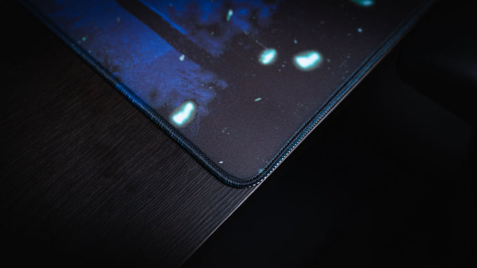 Close-up of precision stitching along a deskmat edge