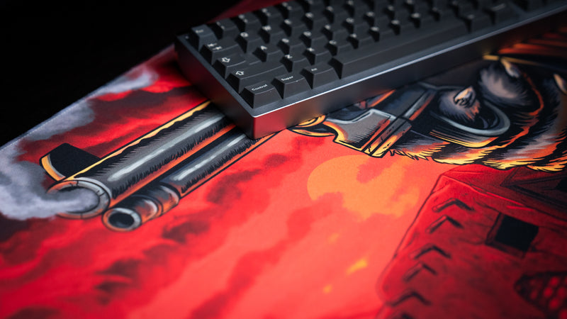 Keyboard resting on Only PVP Cat deskmat beside the smoking revolver artwork, with the printed fabric surface visible.