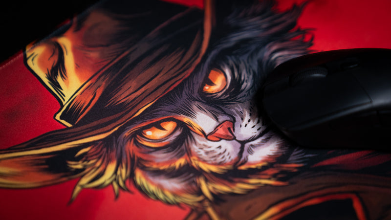 Black gaming mouse beside the cowboy cat's orange eyes and brown hat on Only PVP Cat deskmat.