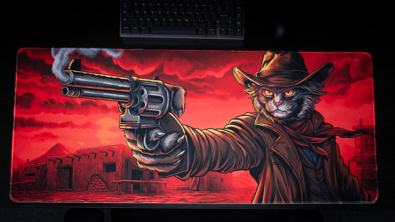 Top view of PVP Cat's Only PVP Cat gaming deskmat showing the complete Western cat artwork beneath a keyboard.