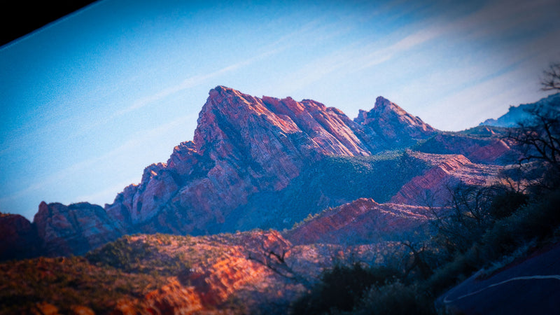 Close-up of the Parus Trail deskmat highlighting the rugged sandstone peaks and dramatic mountain landscape of Zion National Park with vibrant natural colors.