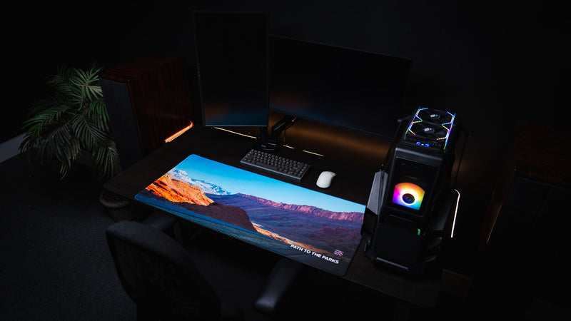 Full gaming setup featuring the Path to the Parks America 250 deskmat with a vivid rural Utah desert landscape, red rock cliffs, snowy mountains, and road artwork.