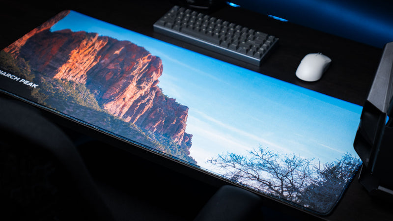 Patriarch Peak deskmat showcasing Zion National Park's towering sandstone cliffs, blue skies, and panoramic landscape with premium stitched edges and vibrant HD photography.