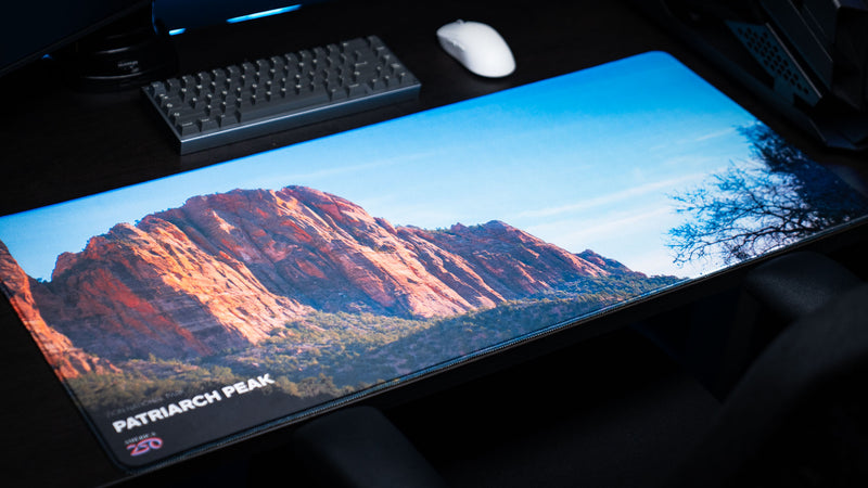 Patriarch Peak deskmat featuring Zion National Park's towering sandstone cliffs in a panoramic landscape with vibrant HD photography, premium stitched edges, and a smooth gaming surface.