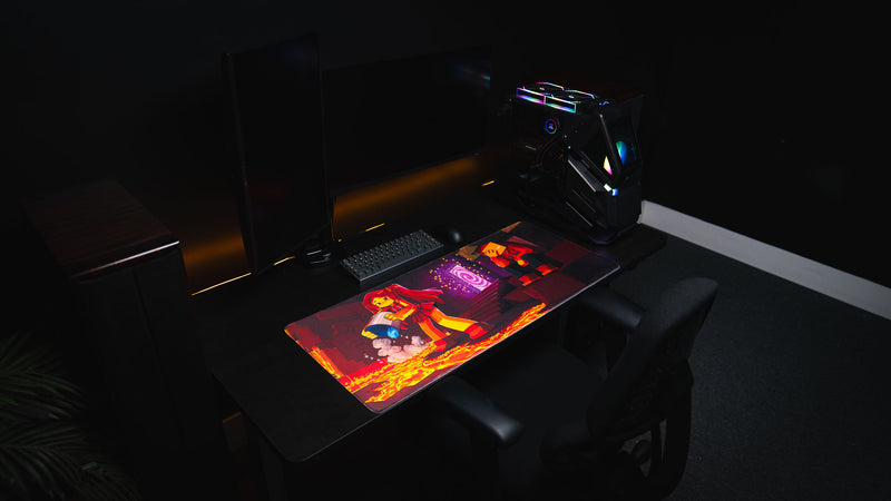 PhoenixSC Phoenix Chan deskmat on a gaming desk with monitor, keyboard, mouse, and PC tower