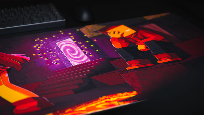 Angled view of the PhoenixSC deskmat showing the purple portal, red-hooded character, and lava edge