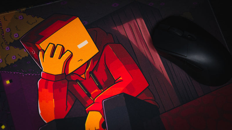 Close-up of the red-hooded character artwork on the PhoenixSC deskmat beside a gaming mouse