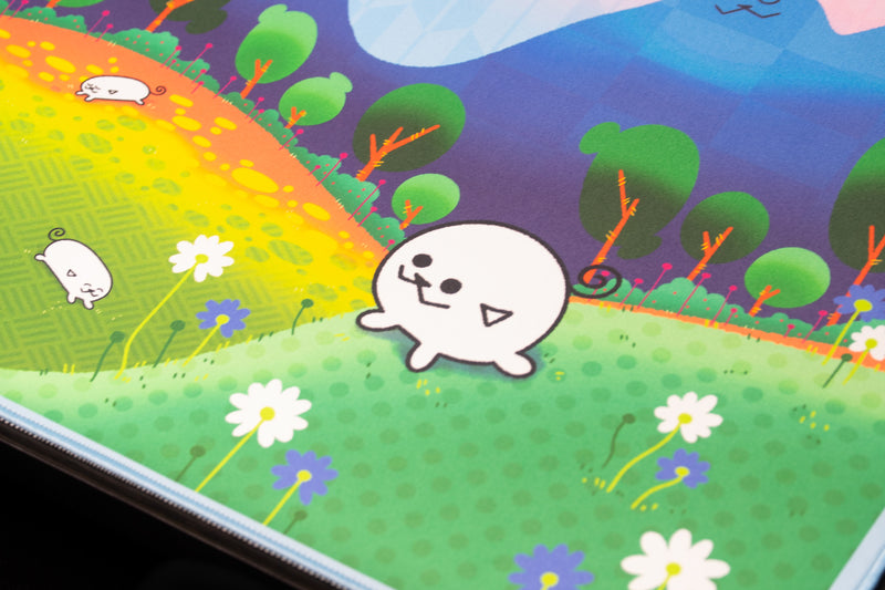 Close-up of a smiling white Pipaland character among daisies and colorful trees on the deskmat.